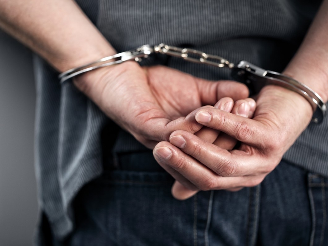 Arrested-man-in-handcuffs-with-85128803
